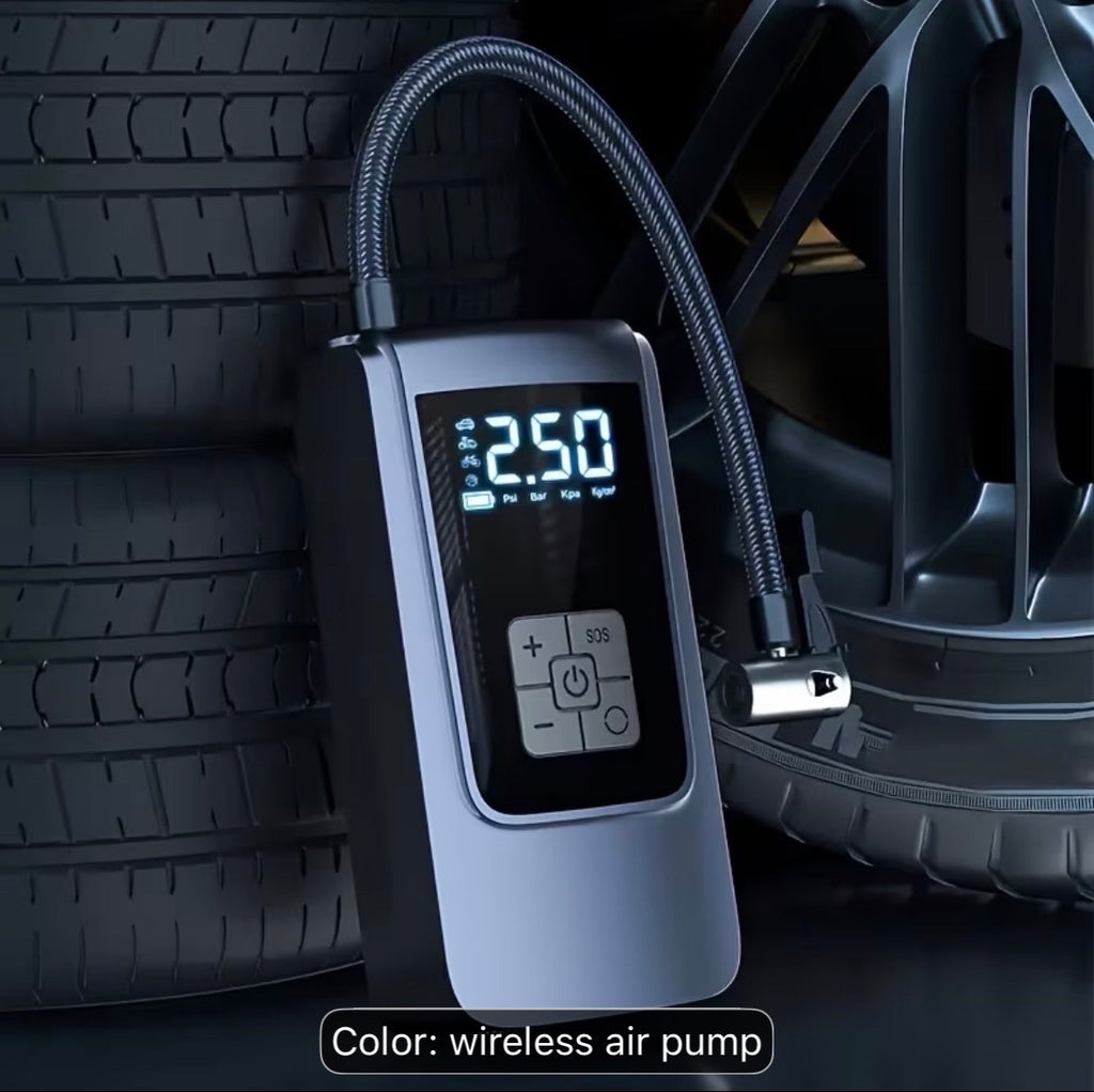 Portable cordless tire inflator standing next to car tires